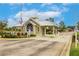 Gated community entrance featuring a guard house and well-maintained landscaping at 2123 Lynx Run, North Port, FL 34288