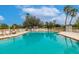 Take a dip in this refreshing community pool surrounded by lush landscaping and sunny skies at 2123 Lynx Run, North Port, FL 34288