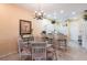 Cozy dining area with stylish chandelier, bar seating, and easy access to kitchen at 2123 Lynx Run, North Port, FL 34288