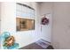 Inviting entrance features a decorated door, window, a colorful chair, and brick flooring at 2123 Lynx Run, North Port, FL 34288