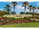 Attractive entrance sign for Bobcat Trail community, surrounded by lush landscaping and palm trees at 2123 Lynx Run, North Port, FL 34288