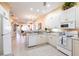 Open kitchen with white cabinets, granite counters, and view to living spaces at 2123 Lynx Run, North Port, FL 34288