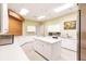Bright kitchen area with large island, plentiful counter space, and stainless steel appliances at 2123 Lynx Run, North Port, FL 34288