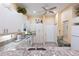 Bright kitchen with white cabinets, granite countertops, and modern appliances at 2123 Lynx Run, North Port, FL 34288