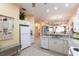 Open kitchen with white cabinets, granite countertops, and stainless appliances at 2123 Lynx Run, North Port, FL 34288