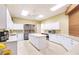 Spacious kitchen with white cabinets, stainless steel appliances, and a central island at 2123 Lynx Run, North Port, FL 34288