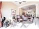 Inviting sunroom with comfortable seating and tiled floor, flowing to open concept living and kitchen at 2123 Lynx Run, North Port, FL 34288