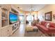 Spacious living room featuring a media center, cozy seating, and tile flooring at 2123 Lynx Run, North Port, FL 34288