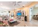 Comfortable living room with tile flooring, entertainment center, and direct access to dining area at 2123 Lynx Run, North Port, FL 34288
