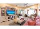 Inviting living room featuring a media center, comfortable seating, and tile flooring at 2123 Lynx Run, North Port, FL 34288