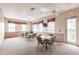 A spacious meeting room with multiple tables, chairs, and large windows for ample sunlight at 2123 Lynx Run, North Port, FL 34288
