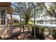 Charming screened patio with brick flooring and beautiful view of the backyard, lush trees, and lake at 2123 Lynx Run, North Port, FL 34288