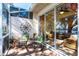 Enclosed patio with cozy seating, brick floor, wall decor, and views through sliding doors to the interior at 2123 Lynx Run, North Port, FL 34288