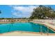 Relaxing swimming pool and lounge chairs overlooking the lake creating an inviting atmosphere for residents to enjoy at 2123 Lynx Run, North Port, FL 34288