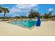 Beautiful swimming pool featuring lounge chairs, shaded tables providing a relaxing area for residents to unwind at 2123 Lynx Run, North Port, FL 34288
