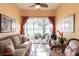 Relaxing sunroom overlooking the lake, with comfortable seating and bright natural light at 2123 Lynx Run, North Port, FL 34288