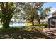 Scenic water view of a lake from the backyard featuring mature trees and lush landscaping at 2123 Lynx Run, North Port, FL 34288