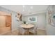 Well-lit dining room featuring a round table with seating for four and vibrant wall decor at 2301 Gulf Of Mexico Dr # 73N, Longboat Key, FL 34228