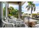 Relaxing balcony with outdoor seating overlooking lush landscaping and waterfront views at 242 Oak Ave, Anna Maria, FL 34216