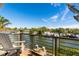 Relaxing outdoor balcony with water views and comfortable seating; perfect for enjoying the scenery at 242 Oak Ave, Anna Maria, FL 34216