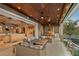 Balcony with water view, seating, outdoor kitchen, and access to interior of home at 242 Oak Ave, Anna Maria, FL 34216