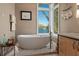 Relaxing bathroom with a modern soaking tub, waterfront views, and stylish fixtures at 242 Oak Ave, Anna Maria, FL 34216