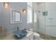 Beautiful bathroom featuring custom blue sink and faucets and seamless glass shower doors at 242 Oak Ave, Anna Maria, FL 34216