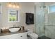Modern bathroom with sleek vanity, glass enclosed shower and elegant finishes at 242 Oak Ave, Anna Maria, FL 34216