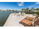 Beach area featuring outdoor seating, a fire pit, and scenic waterfront views at 242 Oak Ave, Anna Maria, FL 34216
