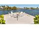Beach area featuring outdoor seating, a fire pit, and waterfront views under a blue sky at 242 Oak Ave, Anna Maria, FL 34216
