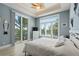 Inviting bedroom with a white color scheme, fan, and private balcony with a view at 242 Oak Ave, Anna Maria, FL 34216
