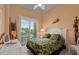 Tropical themed bedroom with a large window view to the outside at 242 Oak Ave, Anna Maria, FL 34216