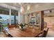 Stunning dining room with wood table, designer lighting and sliding glass doors with waterfront view at 242 Oak Ave, Anna Maria, FL 34216