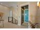 Elegant foyer features a modern elevator, beautiful staircase, and designer lighting at 242 Oak Ave, Anna Maria, FL 34216