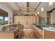 Spacious kitchen with light wood cabinetry, modern appliances, island, and view of the outside at 242 Oak Ave, Anna Maria, FL 34216