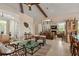 Bright living room with bamboo accents, beamed ceiling, and office area visible through an open doorway at 242 Oak Ave, Anna Maria, FL 34216