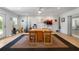 Large living room with wood floors, a ceiling fan, and lots of natural light at 242 Oak Ave, Anna Maria, FL 34216