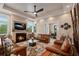 Cozy living room with fireplace, large television, and comfortable leather seating at 242 Oak Ave, Anna Maria, FL 34216