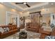 Living room featuring beamed ceiling, bamboo accents, and view into dining area at 242 Oak Ave, Anna Maria, FL 34216
