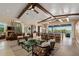 Airy living room with high ceilings, comfortable seating, and open kitchen at 242 Oak Ave, Anna Maria, FL 34216