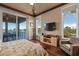 Main bedroom features a private deck overlooking the water, beamed ceilings and wood flooring at 242 Oak Ave, Anna Maria, FL 34216