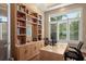 Bright office features custom built-ins, large window with shutters, and a serene workspace at 242 Oak Ave, Anna Maria, FL 34216