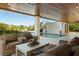Inviting outdoor seating area overlooking the pool and tropical landscaping at 242 Oak Ave, Anna Maria, FL 34216