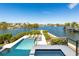 Modern pool and spa with waterfront views and manicured landscaping at 242 Oak Ave, Anna Maria, FL 34216