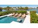 Luxury pool with sun loungers and inset table offering the ultimate outdoor relaxation at 242 Oak Ave, Anna Maria, FL 34216
