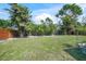 Expansive backyard featuring a well-manicured lawn and privacy fence, offering ample space for outdoor activities at 2427 Tulip St, Sarasota, FL 34239