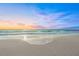 Calm waves meet the shore at sunset, creating a picturesque and peaceful beach scene at 2427 Tulip St, Sarasota, FL 34239