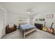 Cozy bedroom with a bed, chair, and dresser, enhanced by natural light and a ceiling fan at 2427 Tulip St, Sarasota, FL 34239