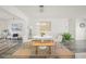 Bright dining area featuring a round table with stylish light fixture, complemented by gray wood floors and modern decor at 2427 Tulip St, Sarasota, FL 34239