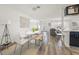 Bright dining area featuring a round table complemented by gray wood floors and a view into the living area at 2427 Tulip St, Sarasota, FL 34239